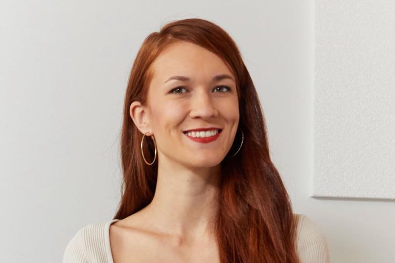 Laura Burget smiling, indoors.