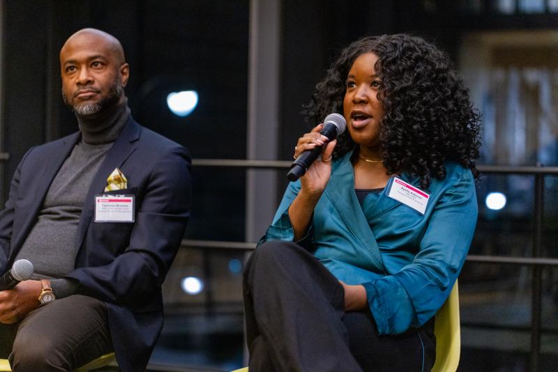 Two panelists speaking on stage