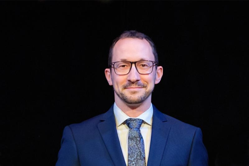 Portrait of Ryan Henderson smiling slightly.