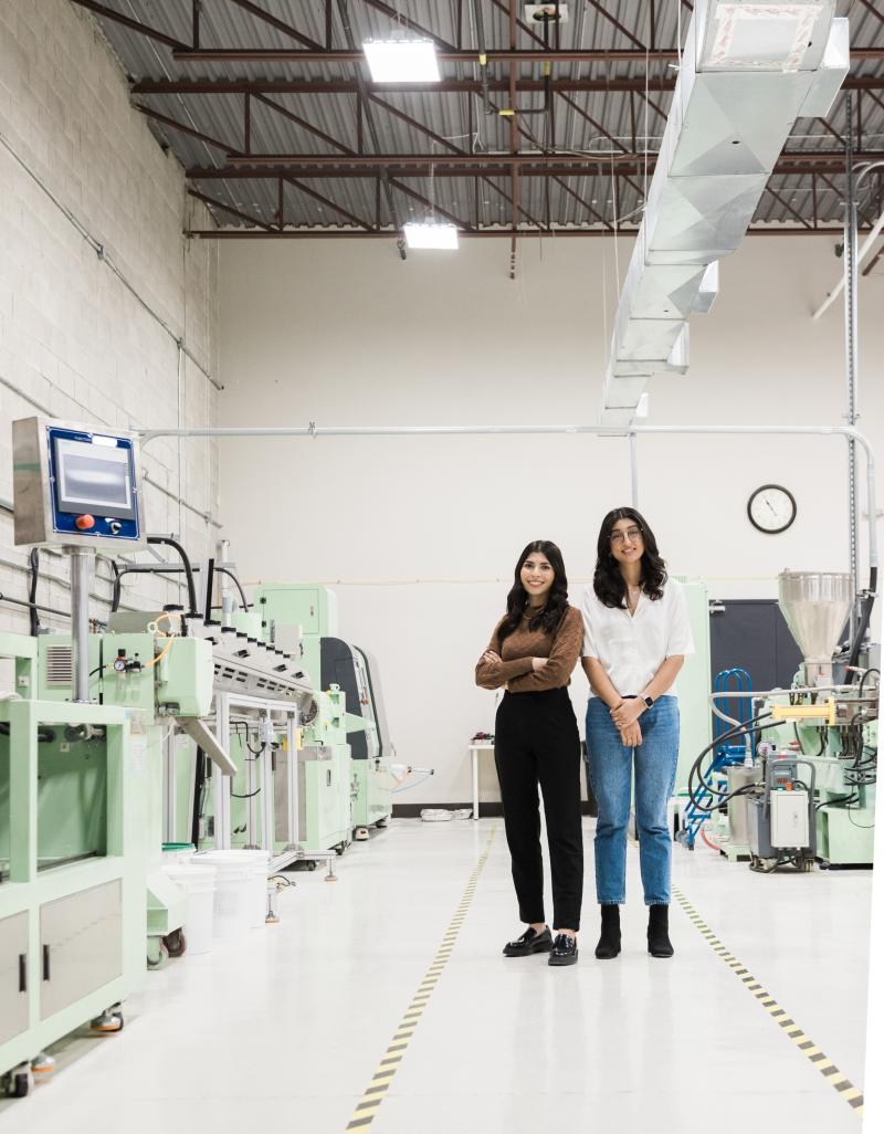 Two young women standing in a lab