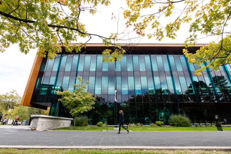 The Hazel McCallion Academic Learning is shaped like a shoebox with wooden sides and an entire wall of glass windows.