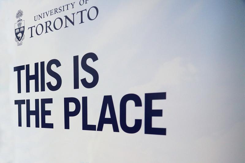 A sign shows the words This is the Place under the University of Toronto logo.