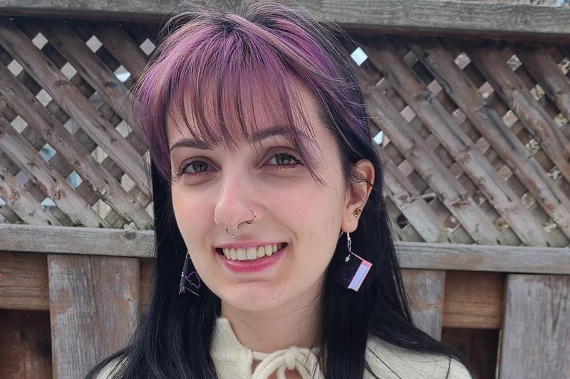Vanessa Parise smiles, standing on a patio outdoors.