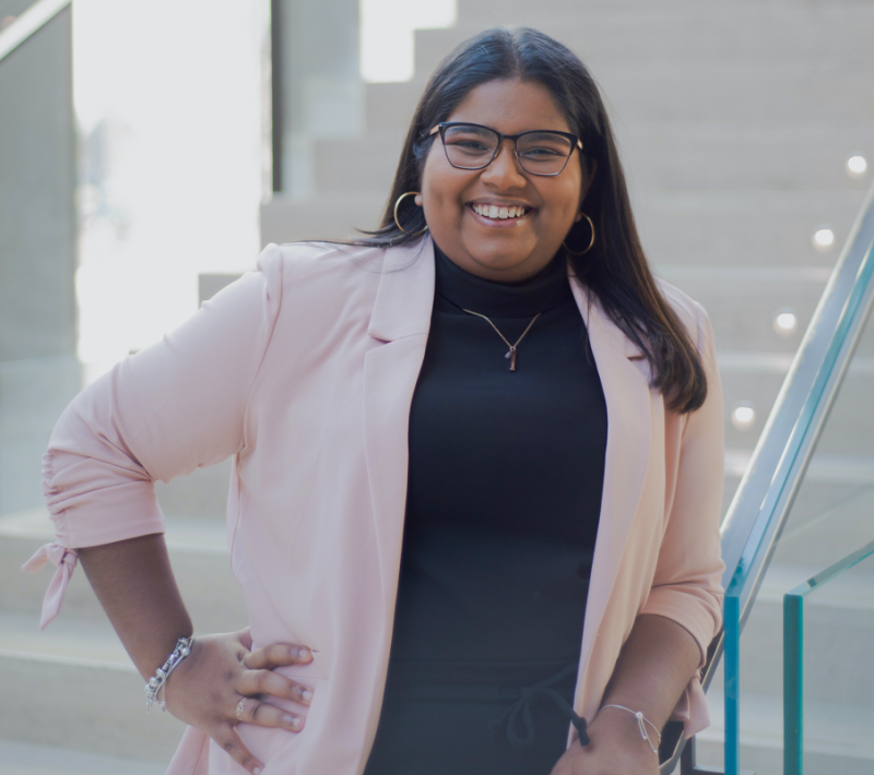 Delicia Raveenthrarajan stands with her hands on her hips