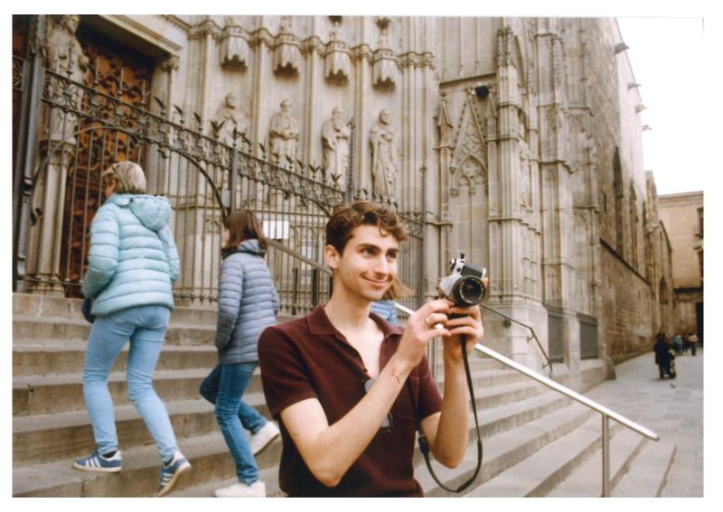 Phil Schwarz takes a photo while standing on the steps of the elaborate Sagrada Familia cathedral in Barcelona.