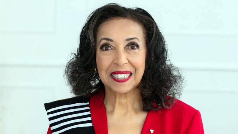 Portrait or Rosemary Sadlier in a red jacket