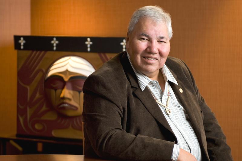 Senator Murray Sinclair is seated in front of the TRC Bentwood Box, carved by Coast Salish artist Luke Marston (photo courtesy of University of Manitoba) 