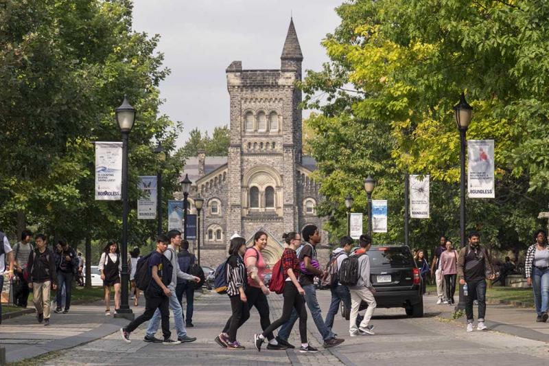 Students cross the road at the University of Toronto. Photo by Geoffrey Vendeville.