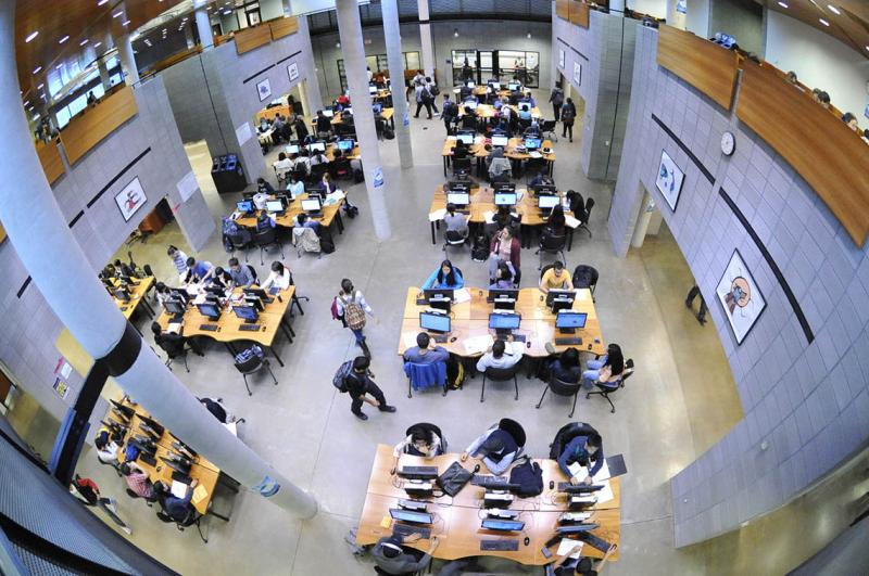 Students conduct research and complete their assignments at the University of Toronto Scarborough Library. Photo by Ken Jones.