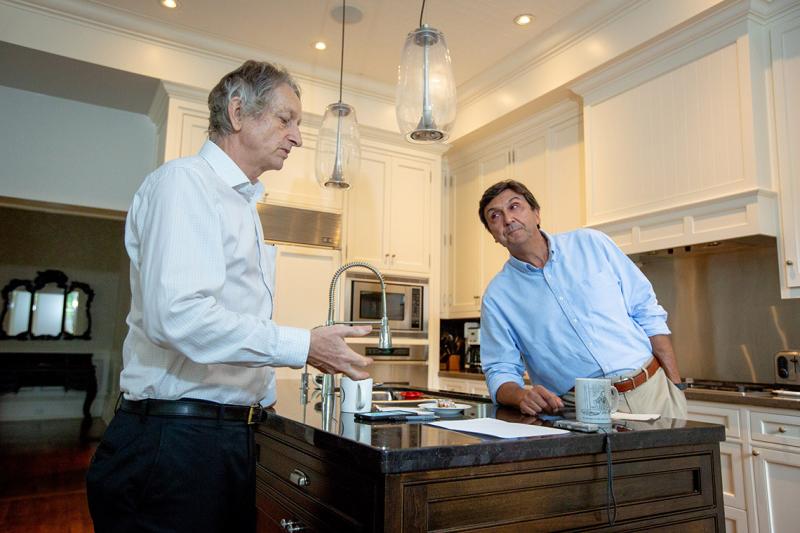 University Professor Emeritus Geoffrey Hinton and U of T President Emeritus Dr. David Naylor discuss the transformative impact of AI on health care in the kitchen of Naylor's Toronto home (photo by Lisa Lightbourn)