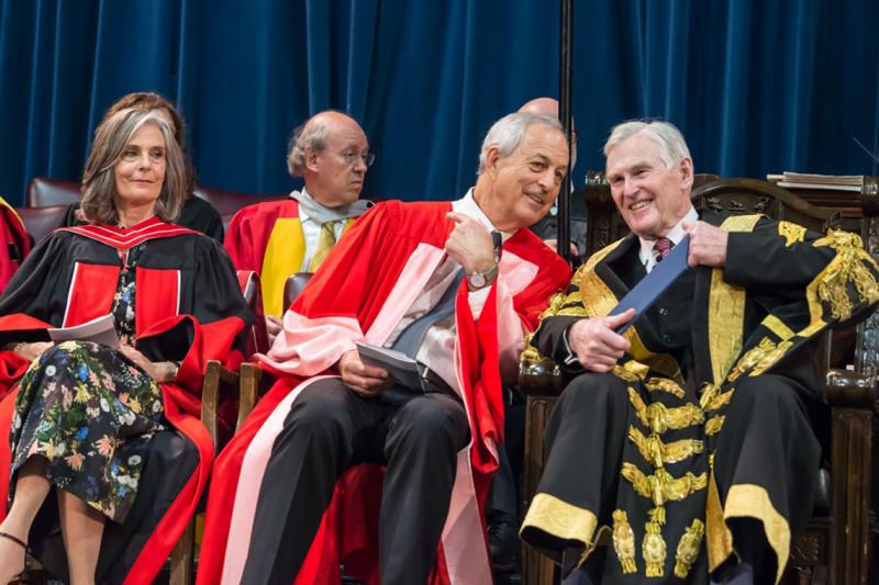Geoffrey Matus, who received an honorary doctor of laws, honoris causa, on Wednesday, speaks to U of T Chancellor Michael Wilson at the convocation ceremony (photo by Steve Frost) 