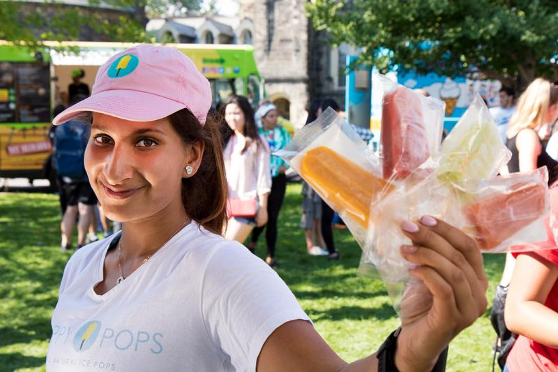 Leila Keshavjee (BKin 2016), who landed a $150,000 deal on CBC's Dragons' Den, shows off her ice pops during U of T's clubs day (photo by Chris Sorensen) 