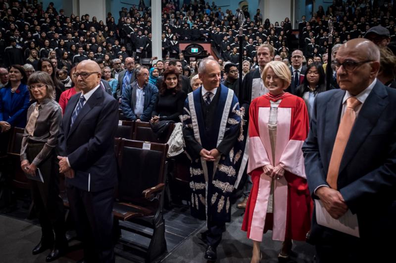 Rose Patten enters Convocation Hall with U of T President Gertler in advance of the robing ceremony. Her husband Tom Di Giacomo is second from the left (photo by Lisa Sakulensky) 