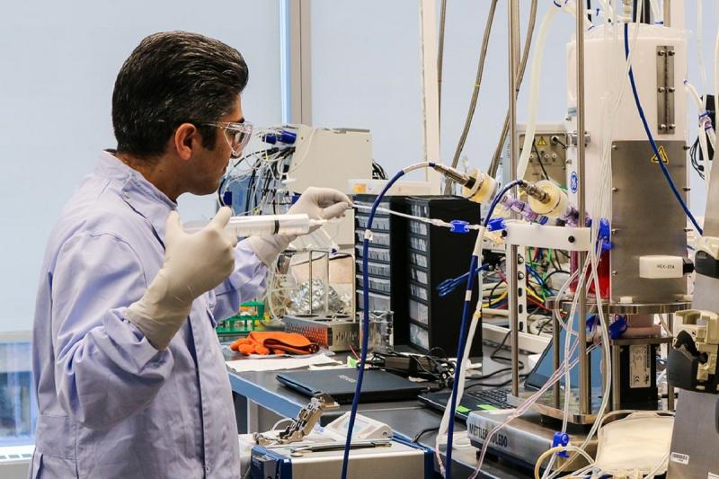 A researcher at the Centre for Advanced Therapeutic Cell Technologies pulls a sample of pluripotent stem cells from a bioreactor. The reactor, which uses disposable bags, can generate up to 25 billion cells at a time (photo by Jennifer Robinson) 
