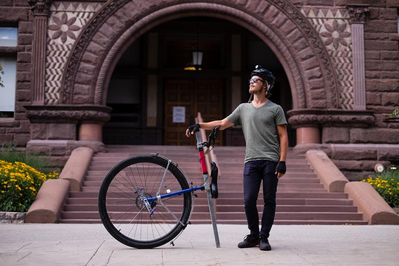 Taylor Stark, a U of T alumnus who is returning for a master's degree in classics, rode his unicycle "Caroline" from Vancouver to Toronto (photo by Geoffrey Vendeville) 