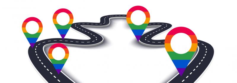 Winding road with rainbow-coloured map pins on it