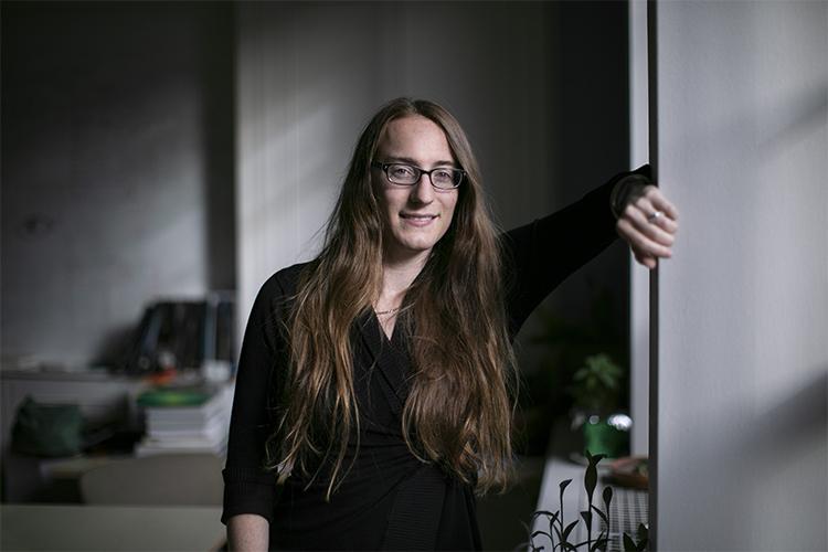 Maria Drout smiles as she leans on the side of a doorway