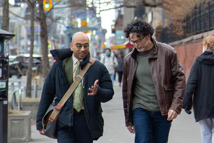 Randy Boyagoda and Rubén Gaztambide-Fernandez chatting while walking.
