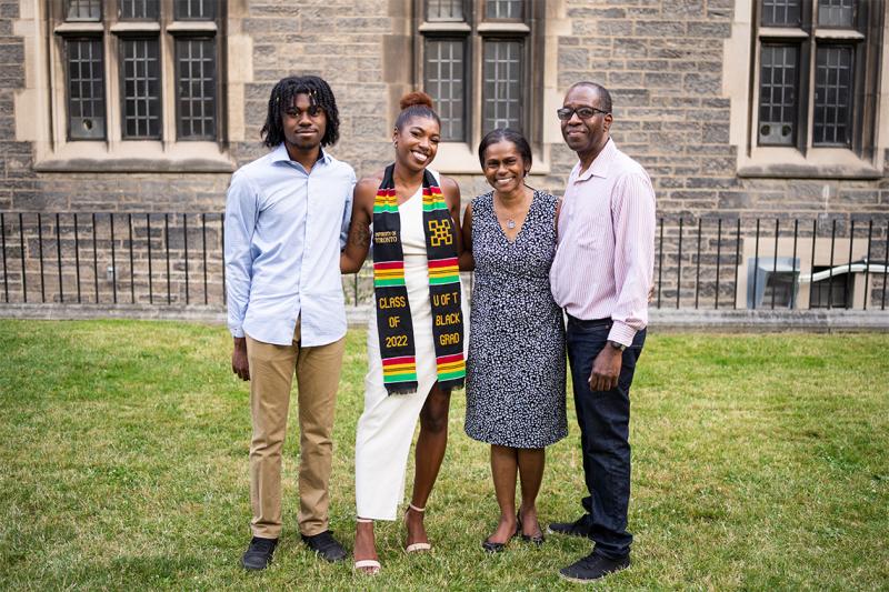 Carae Henry smiles happily, posing for a picture with her brother and parents.