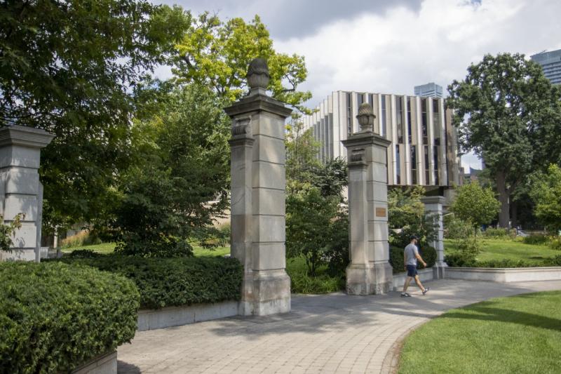 Stone pillars surrounded by garden beds mark the entrance to Philosopher's Walk.