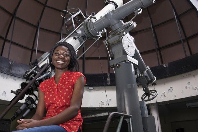 Student with telescope at McLennan Physical Laboratories. (photo by Geoffrey Vendeville)