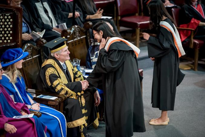 Wilson greets graduating students at Thursday's convocation of Rotman Commerce (photo by Steve Frost)