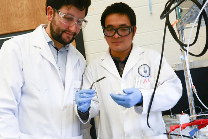 Pelayo Garcia De Arquer (left) and Cao Thang Dinh (right) examine a wafer coated in their new catalyst (photo by Tyler Irving)