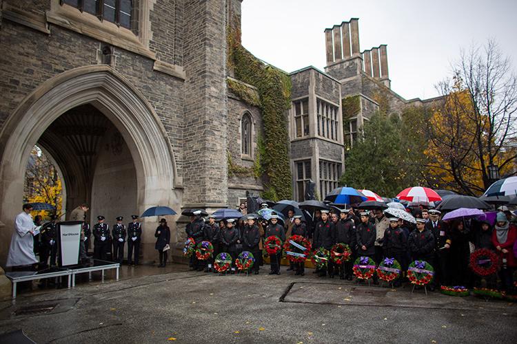 A large crowd braves the wind and rain during a service of remembrance on U of T's downtown Toronto campus (photo by Nick Iwanyshyn)