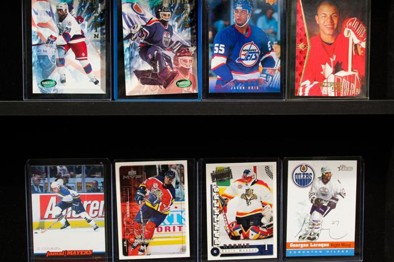 A close-up of 8 hockey cards featuring pictures of Black players.