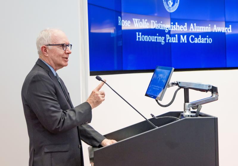 Paul Cadario stands at a podium giving a speech.