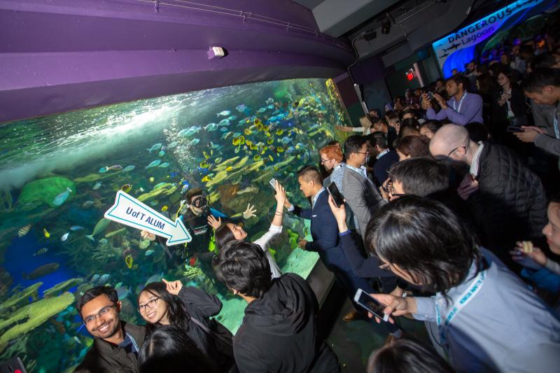 Crowd of young alumni inside Ripley's Aquarium