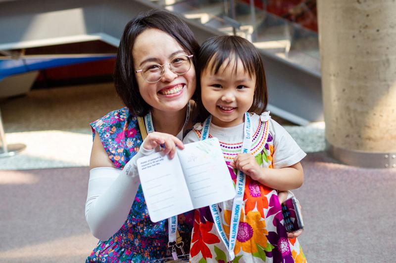 Mother and daughter showing drawing at kids passport.