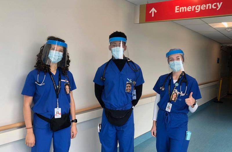 Ivona Berger, Kristian McCarthy and Caroline Gregory wearing protective equipment and portraits, and giving the thumbs up.