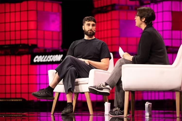 Two people sitting in shares and having a discussion on stage