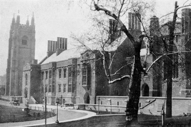 Snowflakes fall in front of Hart House in a wintry scene from the 1920s.