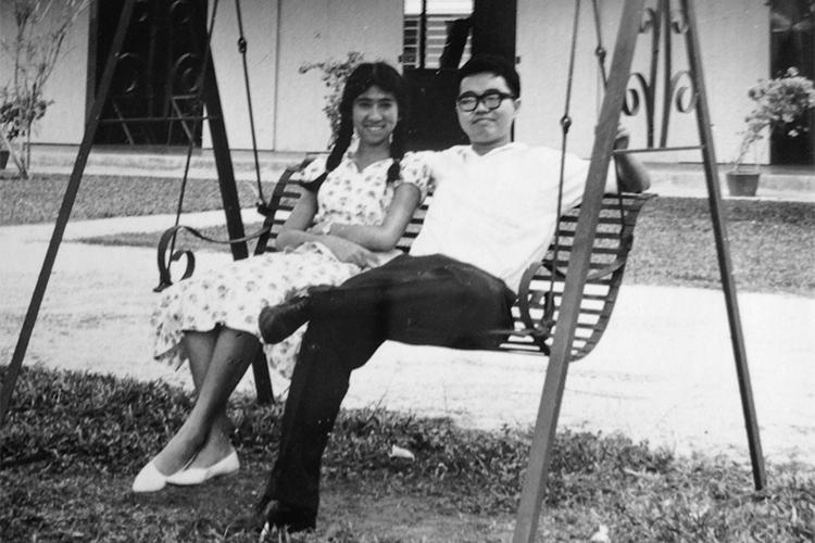 Eng and C.C. Liew smile as they sit together on a bench swing in the early 1960s.