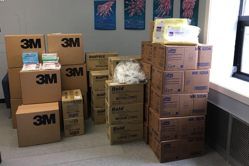 A stack of dozens of boxes of protective equipment donated from U of T labs.