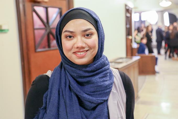 Umme Juthi Jamila smiles as she stands in the lobby of Convocation Hall