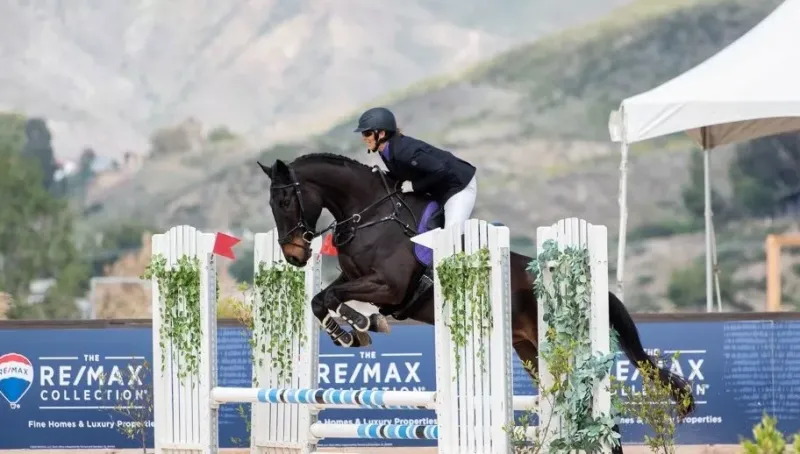 Lorraine on a horse jumping over a fence