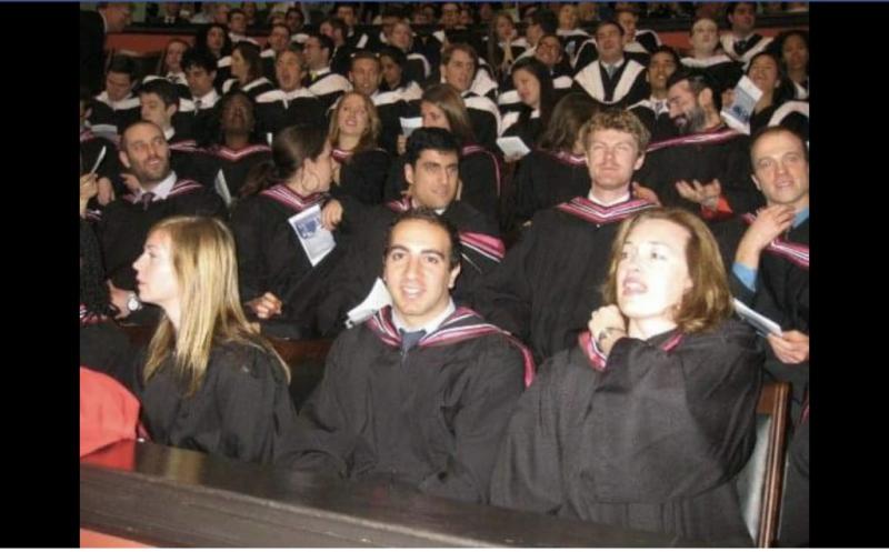 Daron Bedrosyan smiles as he sits with other graduates in Convocation Hall.