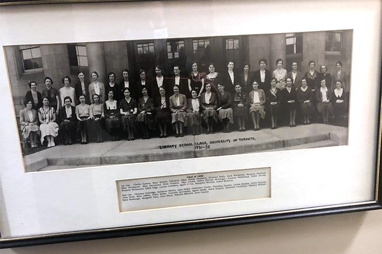 A framed photograph of people posed formally in rows, and labelled Library School Class, University of Toronto, 1931-32.