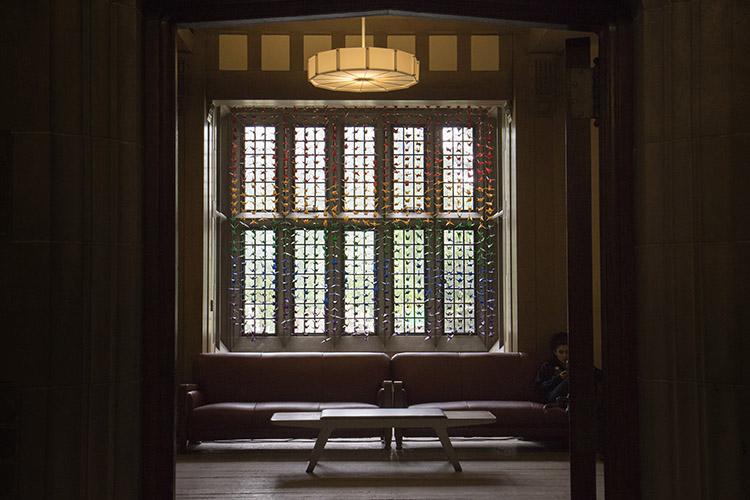 Cranes in the colours of the rainbow hang from a window at Hart House's reading room in June to mark Pride (photo by Romi Levine)