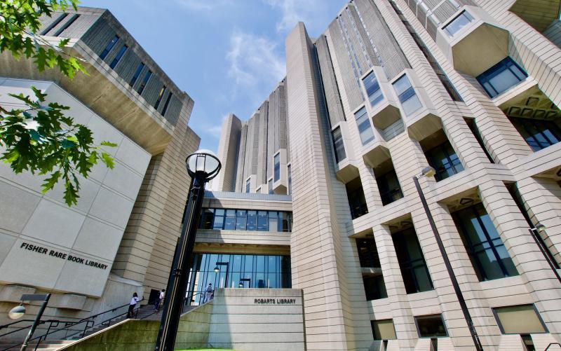 A staircase climbs upwards in a corner in the tall concrete facade of Robarts Library.