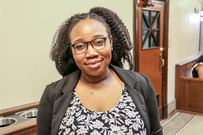 Sherice Robertson smiling and standing in the hallway at Convocation Hall