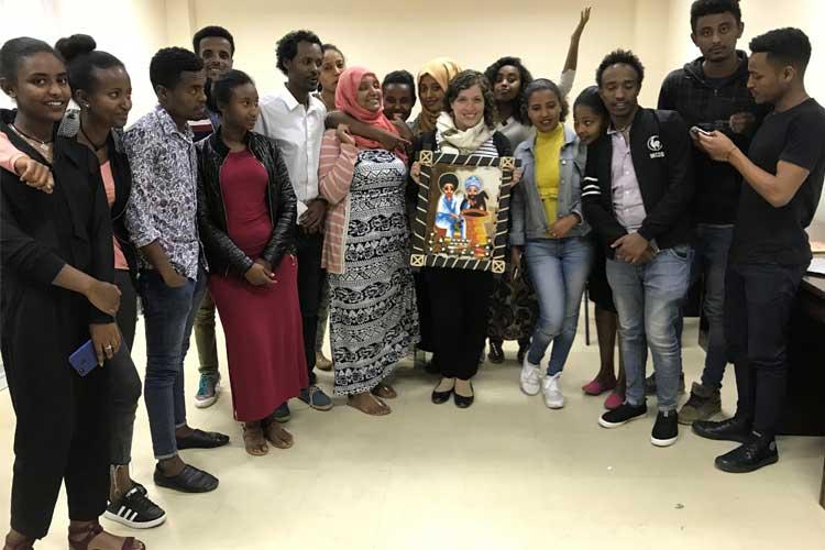 Ganek with speech language pathology students, who gave her this painting as a gift before she went back to Canada (photo courtesy of Hillary Ganek)