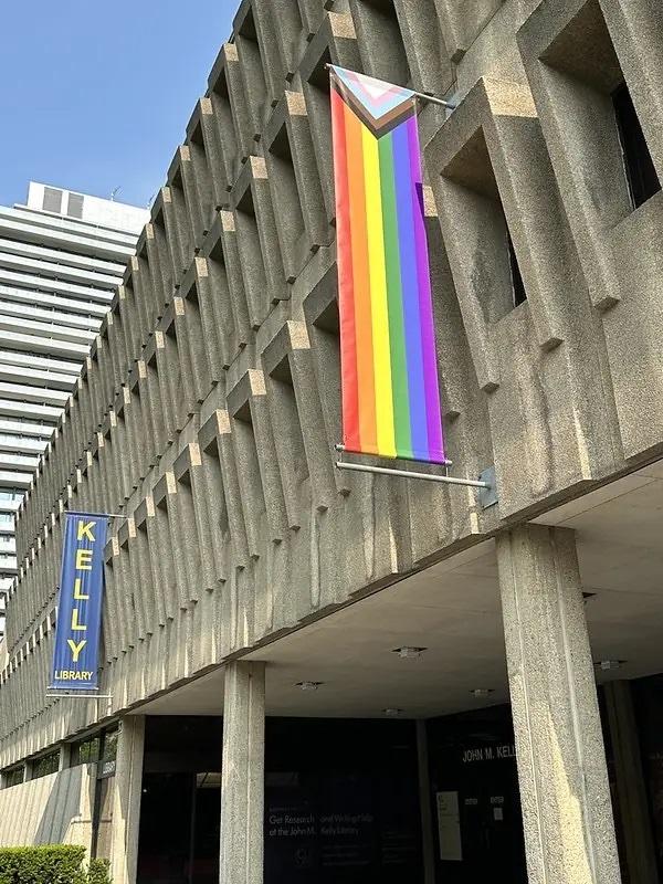 The exterior of brutalist building with a Pride flag.