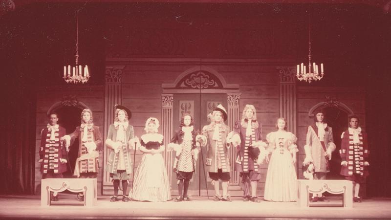 An archival image of actors bowing on a stage