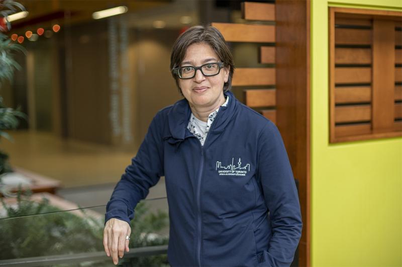 Tara Vindorai wearing a U of T sweatshirt with the Toronto skyline drawn on the front.