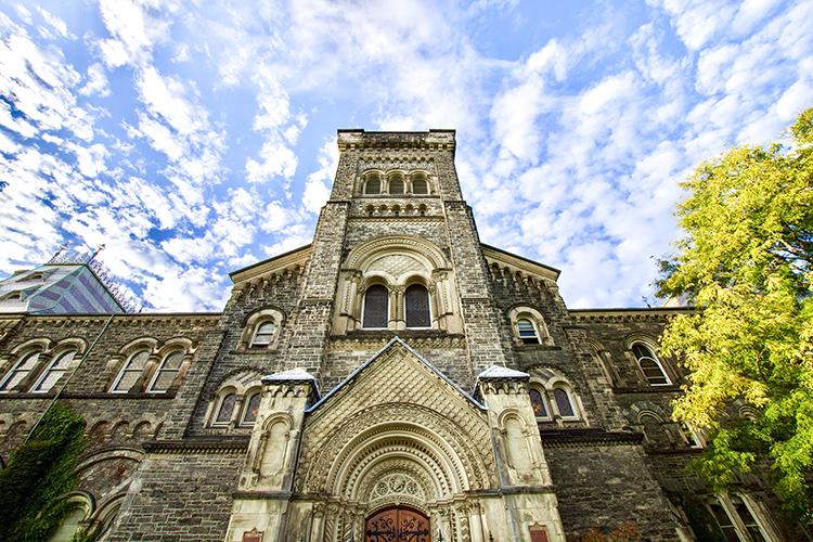 The central tower of University College features a massive elaborately carved arch over the central door.