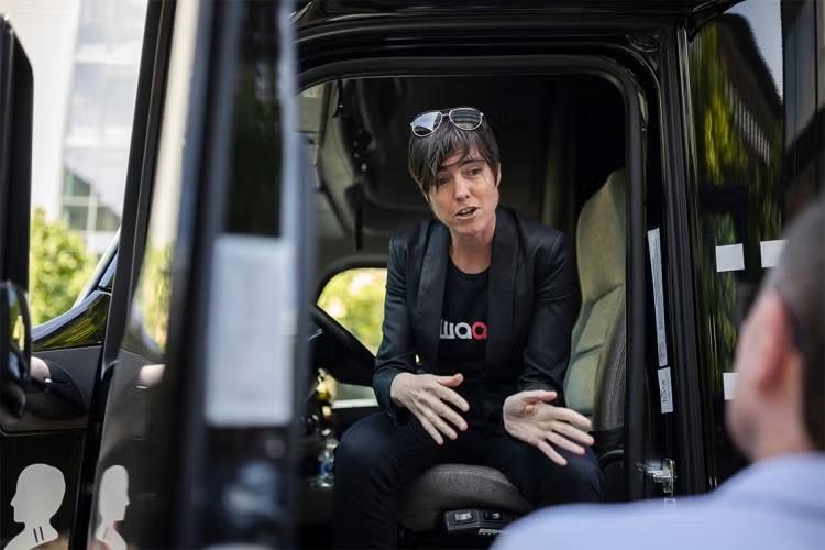 Raquel Urtasun sitting in the front of a truck with the door pen